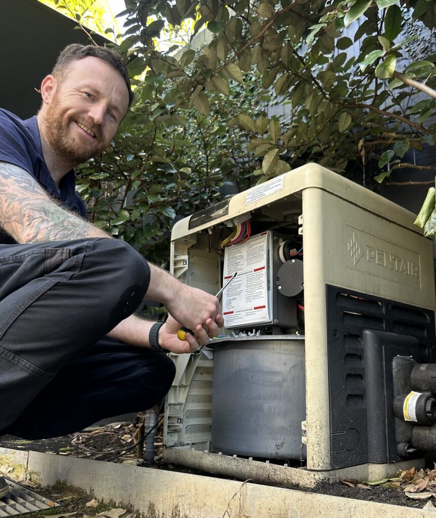 Licensed gas fitter working on an opened Pentair gas pool heater